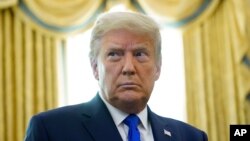 In this Dec. 7, 2020 photo President Donald Trump in the Oval Office of the White House in Washington.
