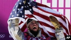 United States' Sage Kotsenburg celebrates after winning the men's snowboard slopestyle final at the Rosa Khutor Extreme Park, at the 2014 Winter Olympics, in Krasnaya Polyana, Russia, Feb. 8, 2014.