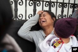 A relative of a youth who resided at the Virgin of the Assumption Safe Home wails as she waits for the release of the names of those who died in a fire at the shelter, outside the morgue where the bodies are being identified in Guatemala City, March 9, 2017.