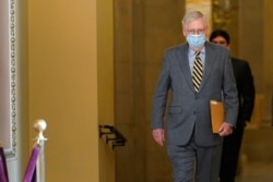 FILE - Senate Majority Leader Mitch McConnell of Kentucky walks to the Senate floor on Capitol Hill in Washington, Dec. 30, 2020.