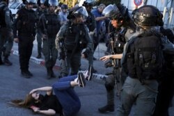 Israeli police scuffle with protesters in the Sheikh Jarrah neighborhood of east Jerusalem on May 15, 2021.