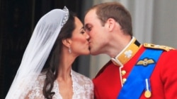 The first kiss: Prince William kisses his wife Kate, Duchess of Cambridge on the balcony of Buckingham Palace. (AP Photo)