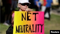 FILE - Lori Erlendsson attends a pro-net neutrality Internet activist rally in the neighborhood where President Barack Obama attended a fundraiser in Los Angeles, California, July 23, 2014. REUTERS/Jonathan Alcorn (UNITED STATES - Tags: CIVIL UNREST POLI