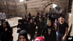 FILE - Mourners hold a march during the funeral of of Mohamed Ali, a 23- year-old driver, who was shot dead overnight during a dispute with a police sergeant, during his funeral in Cairo, Egypt, Feb. 19, 2016.
