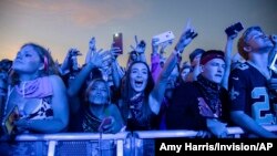 FILE - Festival-goers attend the Voodoo Music Experience in City Park in New Orleans, Oct. 27, 2019. Major concert promoters in the U.S. are stepping back from plans to scan festival-goers with facial recognition technology, at least for the time being.