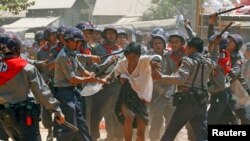 Police are seen hitting a student demonstrator during a crackdown on protests in Letpadan March 10, 2015.