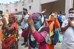 Hindu devotees offer prayers in front of a chariot carrying an idol of Lord Jagannath (not pictured) as the annual Rath Yatra procession was cancelled amid concerns over the spread of the COVID-19 coronavirus, in Ahmedabad, June 23, 2020.