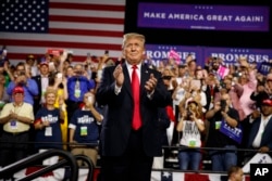 FILE - President Donald Trump arrives to speak at a campaign rally at Florida State Fairgrounds Expo Hall, July 31, 2018, in Tampa, Fla.