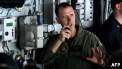 U.S. Chief of Naval Operations Admiral John Richardson addresses all crew from the bridge of the USS George H.W. Bush as it conducted joint training operations with the French navy off Virginia, May 14, 2018.