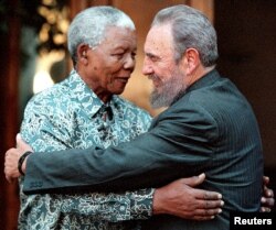 FILE - Former South African President Nelson Mandela (L) hugs Cuba's President Fidel Castro during a visit to Mandela's home in Houghton, Johannesburg, Sept. 2, 2001.