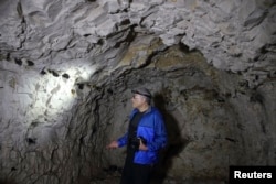 Jeffrey Gusky, a US medic who for the past 20 years has gathered images for a photo project called "The Hidden World of WWI", looks at inscriptions by WWI soldiers in underground caves accessible by small spiral stairs in the village's church at Bouzincou