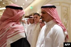 Salah Khashoggi, right, the son of murdered Saudi journalist Jamal Khashoggi, and his relatives receive mourners at an events hall in the Saudi coastal city of Jeddah, Nov. 16, 2018.