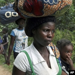 Refugees from Ivory Coast walk with their their belongings through Grand Gedeh county in eastern Liberia Mar 23 2011