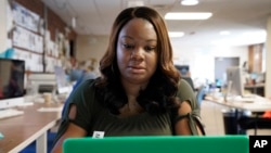 Dana Anthony works at her desk at The Daily Tar Heel newspaper in Chapel Hill, N.C., Tuesday, April 13, 2021. Anthony was rejected after two separate video interviews for jobs. (AP Photo/Gerry Broome)