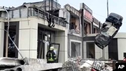 Saturday, Feb. 3, 2024, Russian Emergency Ministry employees work at the side of a collapsed bakery after an attack of Ukrainian troops in Luhansk region (Russian Emergency Ministry Press Service via AP)