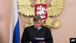 FILE - Russia's Supreme Court judge Yuri Ivanenko reads the decision in a court room in Moscow, Russia, April 20, 2017. Russia's Supreme Court has rejected an appeal of its nationwide ban on the Jehovah's Witnesses.