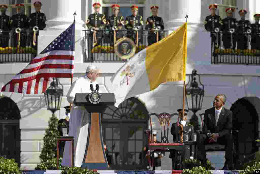 Pope Francis turns toward President Barack Obama during his welcoming remarks at the state arrival ceremony in his honor on the South Lawn of the White House, Sept. 23, 2015.