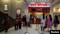 People stand outside a ticket counter at the Atrium Cinema in Karachi, Pakistan, Dec. 19, 2016.