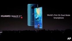 FILE - Richard Yu, CEO of the Huawei consumer business group, presents new devices in Munich, Germany, Sept. 19, 2019. Microsoft was granted a license to sell software to the telecoms giant.
