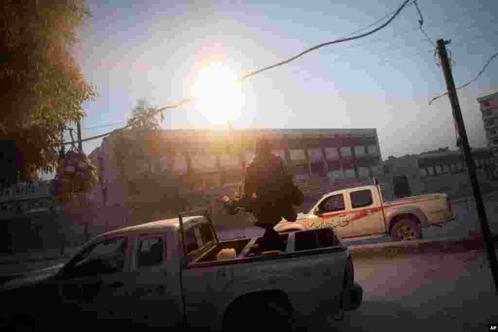A Free Syrian Army fighter fires an anti-aircraft machine gun against a Syrian Army jet in the Saif Al Dula district in Aleppo, September 19, 2012.