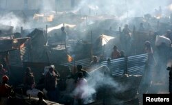 People displaced during post-election violence are seen in a temporary shelter in Burnt Forest, Kenya, Jan. 6, 2008.