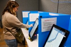 Courtney Parker votes on a new voting machine, Tuesday, Nov. 5, 2019, in Dallas, Ga.