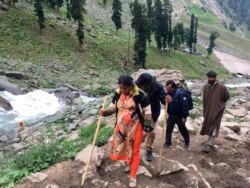 FILE - Hindu pilgrims walk uphill as they participate in the annual amarnath pilgrimage near Chandanwa, Indian-controlled Kashmir, July 27, 2019.