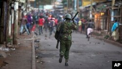FILE - Opposition supporters run from police during clashes after the election commission announced results from the Oct. 26 vote in the Kibera area of Nairobi, Kenya, Oct. 30, 2017.