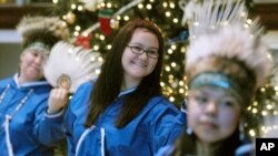 Debra Dommek,an Inupiaq Native, center, performs traditional dances at the Alaska Native Heritage Center in Anchorage, Alaska Saturday, Dec. 16, 2006.( AP Photo/Michael Dinneen)