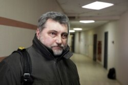 Andrei Bastunets, the head of the Belarusian Association of Journalists speaks to the media after having documents and computers confiscated from the office in Minsk, Belarus, Feb. 16, 2021.