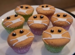 Timed to the current outbreak of the worldwide coronavirus, Covid-Free Cupcakes with icing masks are on display in the Cheesecake House and Restaurant in Bangkok, Thailand, Monday, March 23, 2020.