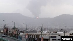 Fire is seen at a military site after it was hit by an airstrike at the Faj Attan mountain of Sanaa, April 6, 2015. 