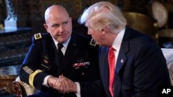 President Donald Trump, right, shakes hands with Army Lt. Gen. H.R. McMaster
