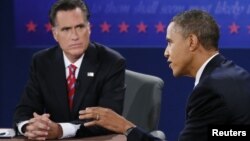 U.S. President Barack Obama speaks as Republican presidential nominee Mitt Romney listens during the final U.S. presidential debate in Boca Raton, Florida, October 22, 2012.