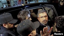 Tahir Elci, the head of Diyarbakir Bar Association, (2nd R) is escorted by plainclothes police officers after his arrest at his office in Diyarbakir, Turkey, Oct. 20, 2015.