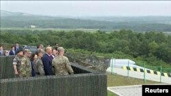 U.S. President Donald Trump and South Korean President Moon Jae-in are seen at the demilitarized zone (DMZ) separating the two Koreas, in Panmunjom, South Korea, in this still image from video taken June 30, 2019.