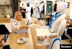 A robot waiter serves customers at a cafe in Budapest, Hungary, Jan. 24, 2019.