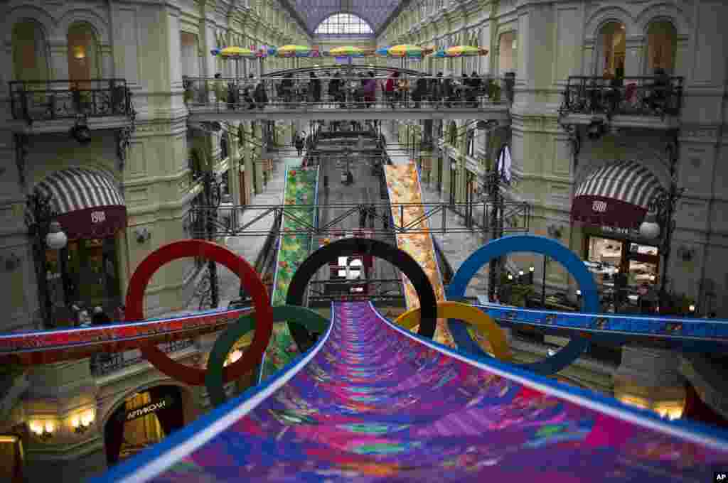 Pengunjung berjalan di dalam department store GUM di Moskow yang dihiasi lambang Olimpiade, 12 Februari 2014.
