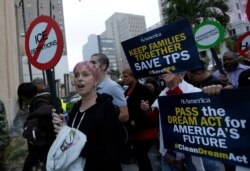 Mercedes Kent, of New York City, left, marches in support of Deferred Action for Childhood Arrivals (DACA) and Temporary Protected Status (TPS) programs for immigrants, Jan. 17, 2018, in Miami.