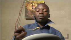 Munyaradzi Masiiwa, having porridge for breakfast at his home in Harare on July 23, 2019, as he cannot afford a loaf of bread due to high cost of living in Zimbabwe.