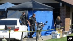 Sacramento County Sheriffs deputies walk to the garage of the Citrus Heights, Calif., home of Joseph James DeAngelo, April 25, 2018. DeAngelo was arrested on suspicion of a string of violent crimes in the 1970s and 1980s. 
