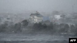 High winds whip water onto the shore of Phuong Luu Lake as Typhoon Yagi hits Hai Phong, Vietnam, on Sept. 7, 2024. Yagi uprooted thousands of trees and swept ships and boats out to sea as it made landfall, state media said.