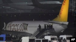Passengers of private Turkish company Pegasus leave the plane at the Sabiha Gokcen Airport in Istanbul, Turkey, Feb. 7, 2014. 