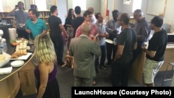 Members gather at the LaunchHouse near Cleveland, Ohio for a "brew and brainstorming" session. Entrepreneurs help each other come up with solutions and business ideas.