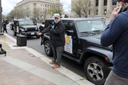 FILE - Chef Jose Andres prepares with members of his World Central Kitchen team to load meals to deliver to people in need during the coronavirus outbreak in downtown Washington, March 31, 2020.