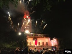 Two commencement traditions at the University of Texas at Austin: lighting up the top of the campus landmark tower in orange - the official color of the university - and fireworks at the end of the ceremony. (C. Presutti/VOA)