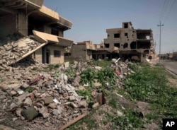 Houses in a residential street are reduced to rubble, on the edge of Hamdaniya, Iraq, March 29, 2017.