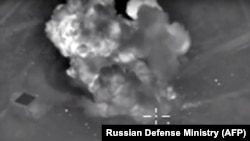 An image taken from video purports to show explosions after airstrikes carried out by Russia's air force on what it said was an Islamic State ammunition depot in the Syrian province of Idlib, Oct. 14, 2015..