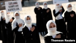 Ethnic Uighur women take part in a protest against China, in Istanbul, Turkey, Oct. 1, 2020. 