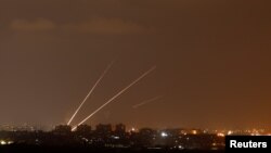 Streaks of light are pictured as rockets are launched from the northern Gaza Strip towards Israel, as seen from Sderot, Israel, Aug. 8, 2018.
